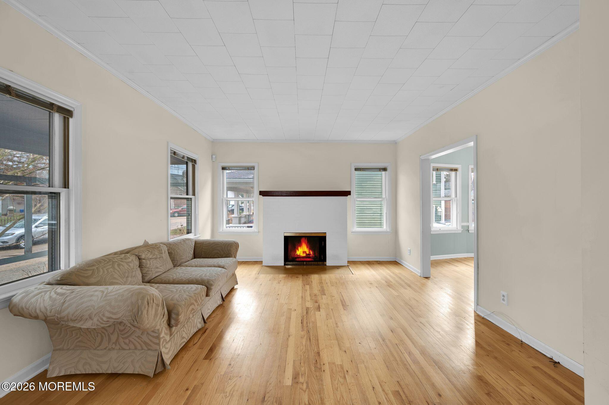 1405 Wanamassa Road Asbury Park, NJ 07712 - Photo 8 of 42 a living room with furniture and a fireplace