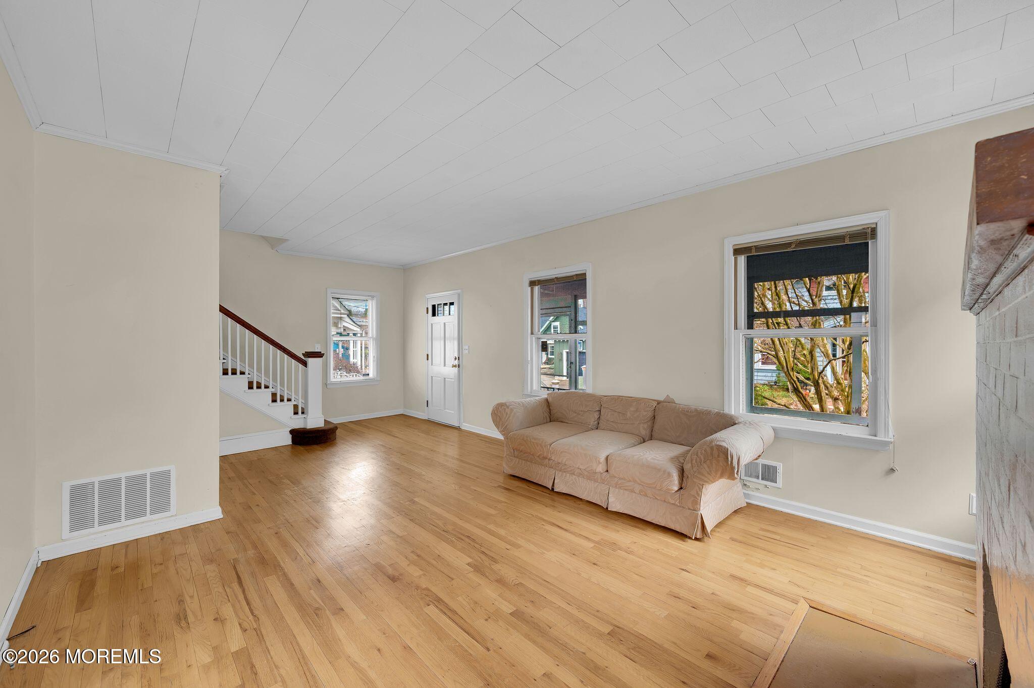1405 Wanamassa Road Asbury Park, NJ 07712 - Photo 10 of 42 a living room with furniture and a window