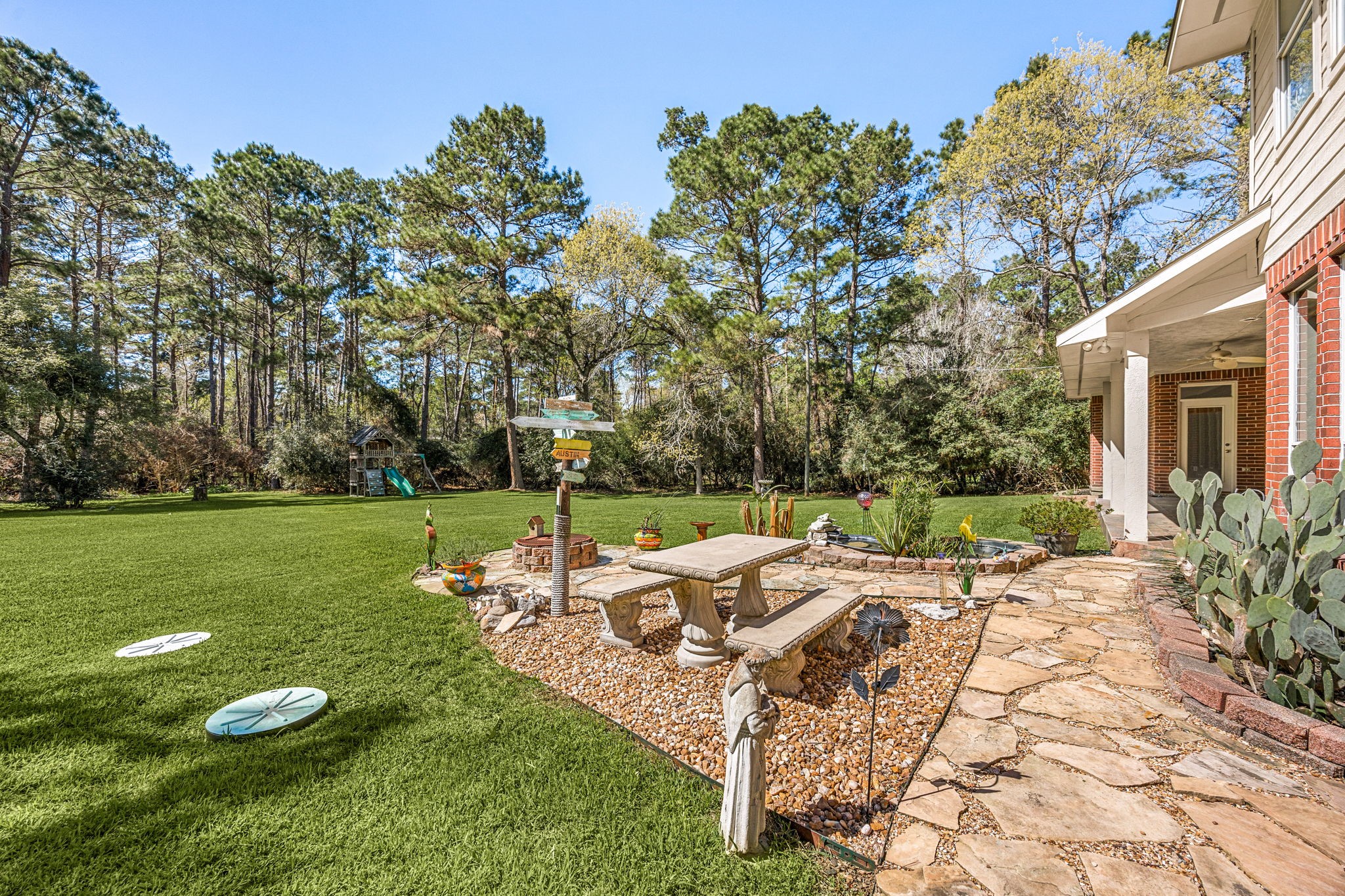 14419 Timbergreen Drive Magnolia, TX 77355 - Photo 31 of 43 Enjoy the peaceful backyard featuring a patio seating area, landscaped garden space, and plenty of room for outdoor gatherings.