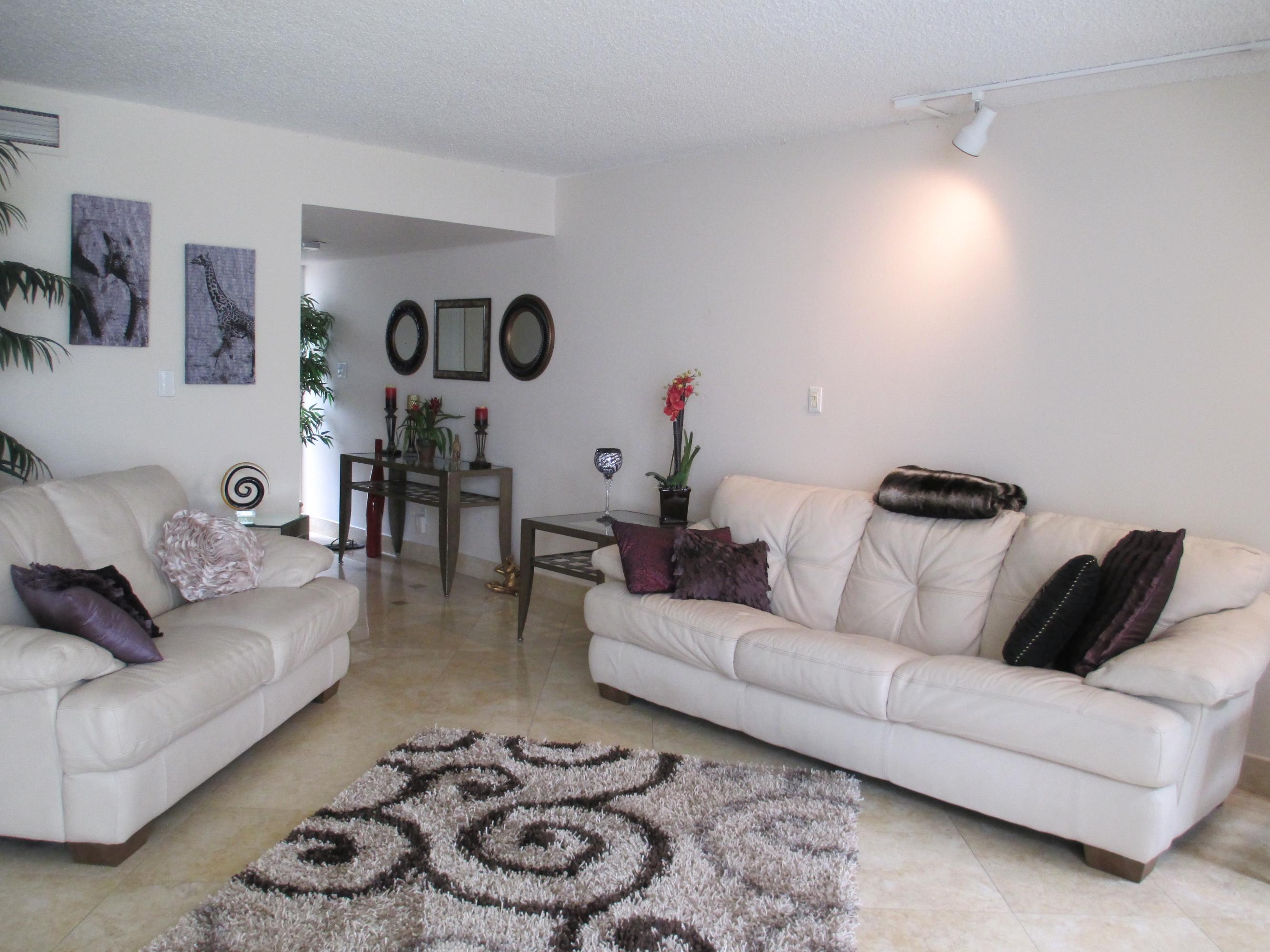 1405 Bridgewood Drive, Unit 1405 Boca Raton, FL 33434 - Photo 11 of 54 a living room with furniture and a couch