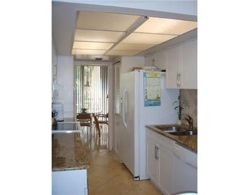 a kitchen with sink and cabinets