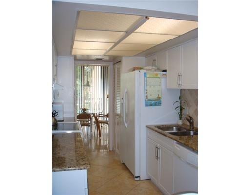 1405 Bridgewood Drive, Unit 1405 Boca Raton, FL 33434 - Photo 15 of 54 a kitchen with sink and cabinets