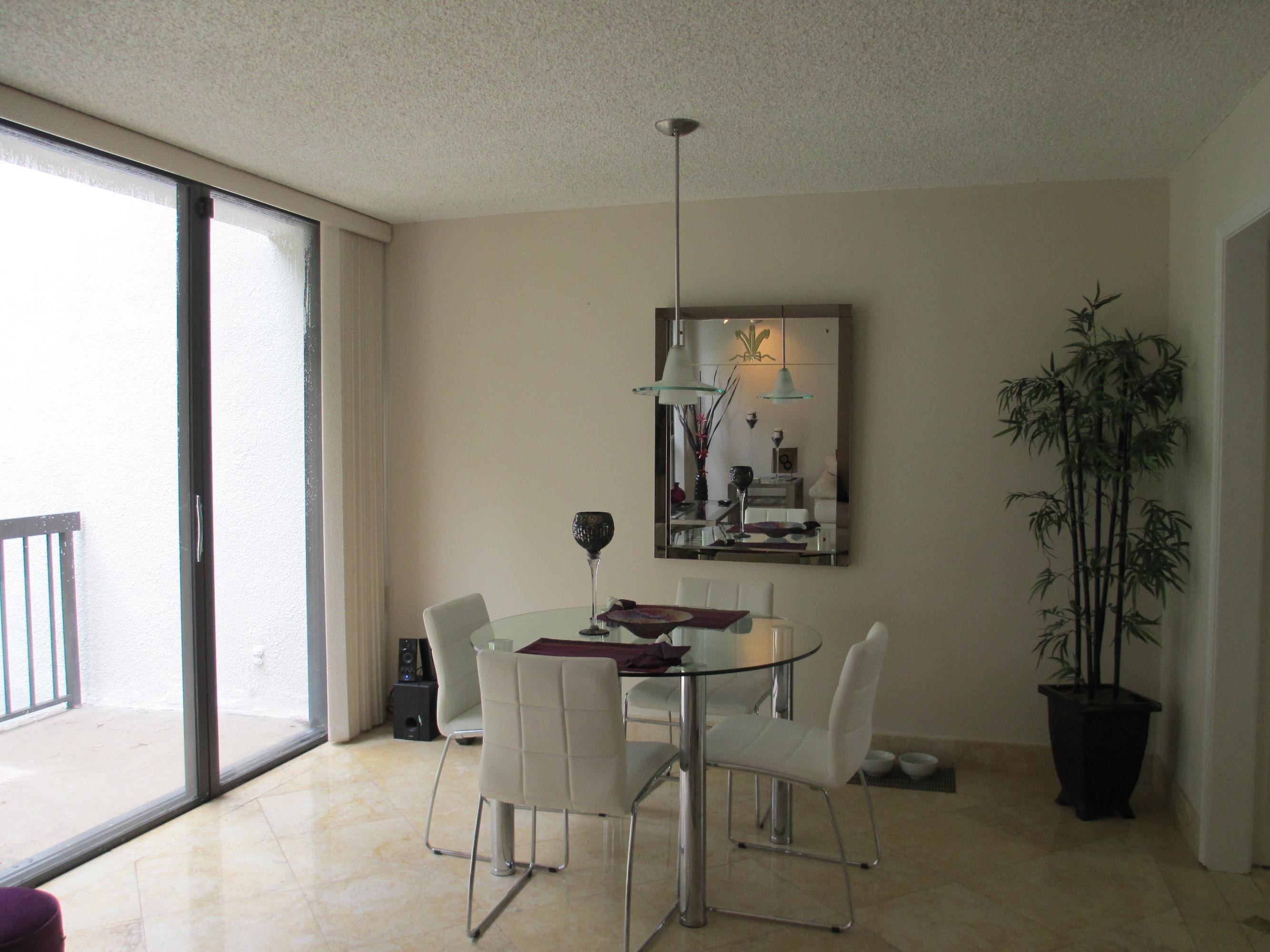 1405 Bridgewood Drive, Unit 1405 Boca Raton, FL 33434 - Photo 16 of 45 a dining room with furniture and window