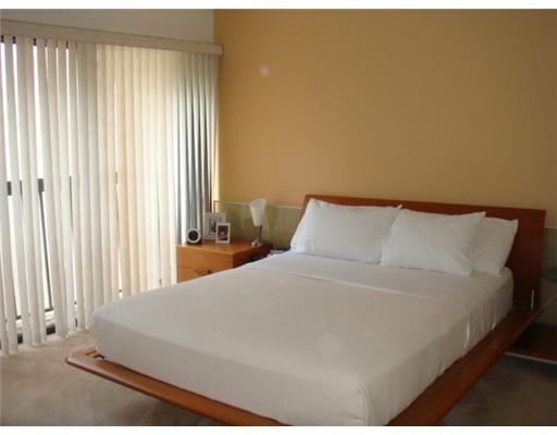 1405 Bridgewood Drive, Unit 1405 Boca Raton, FL 33434 - Photo 19 of 45 a large bed sitting in a bedroom next to a window