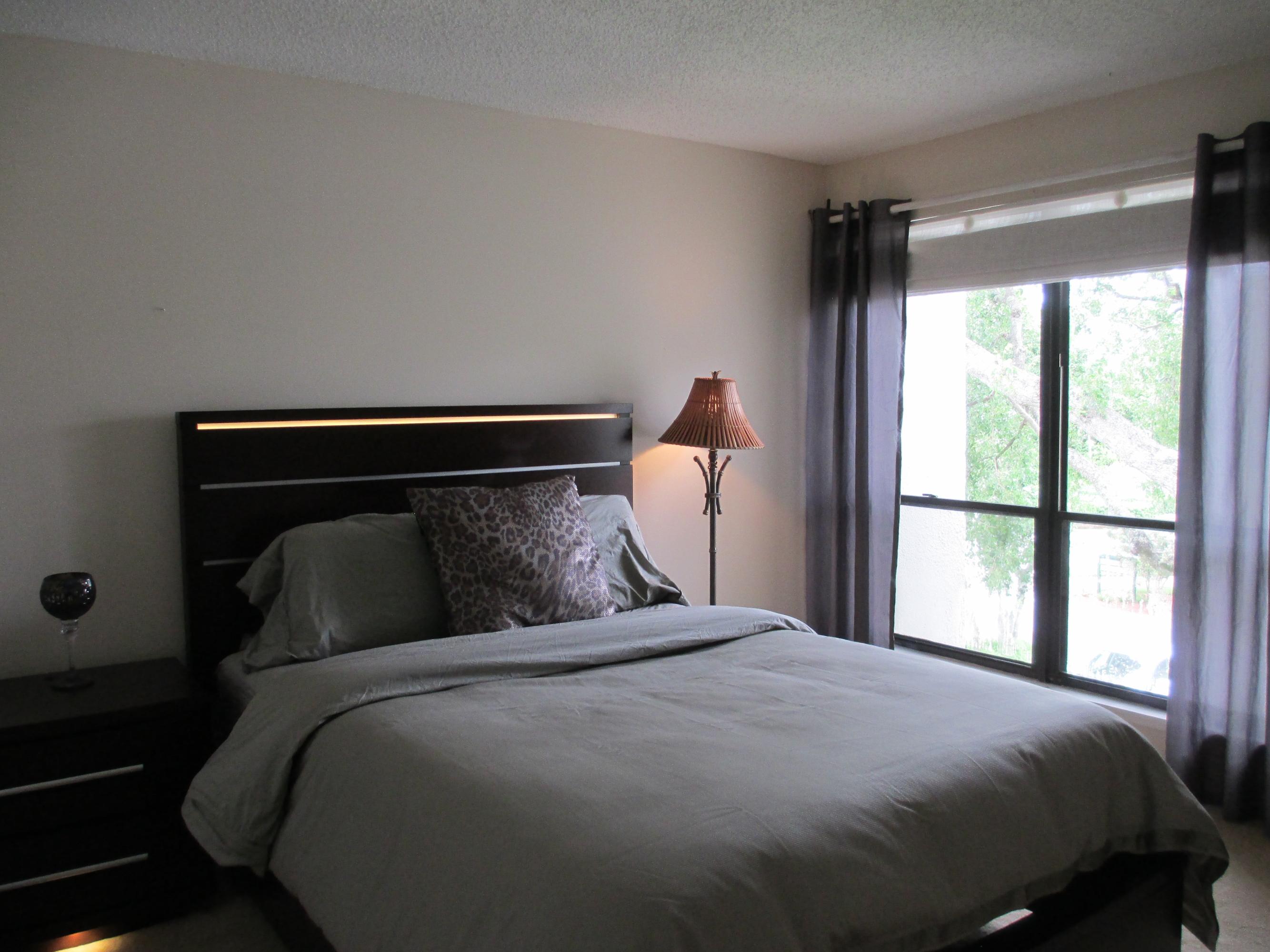 1405 Bridgewood Drive, Unit 1405 Boca Raton, FL 33434 - Photo 20 of 45 a bedroom with a bed and a window