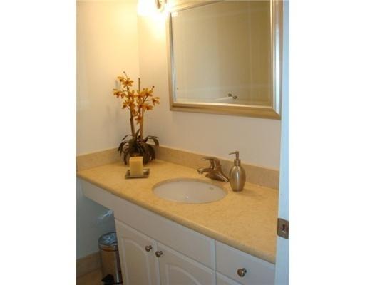 1405 Bridgewood Drive, Unit 1405 Boca Raton, FL 33434 - Photo 25 of 45 a bathroom with a granite countertop sink and a mirror