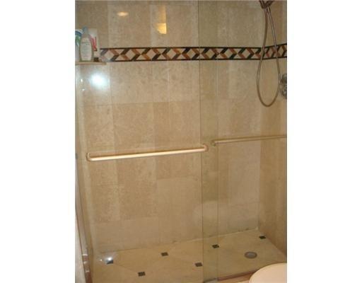 1405 Bridgewood Drive, Unit 1405 Boca Raton, FL 33434 - Photo 30 of 54 a bathroom with a shower and a glass door