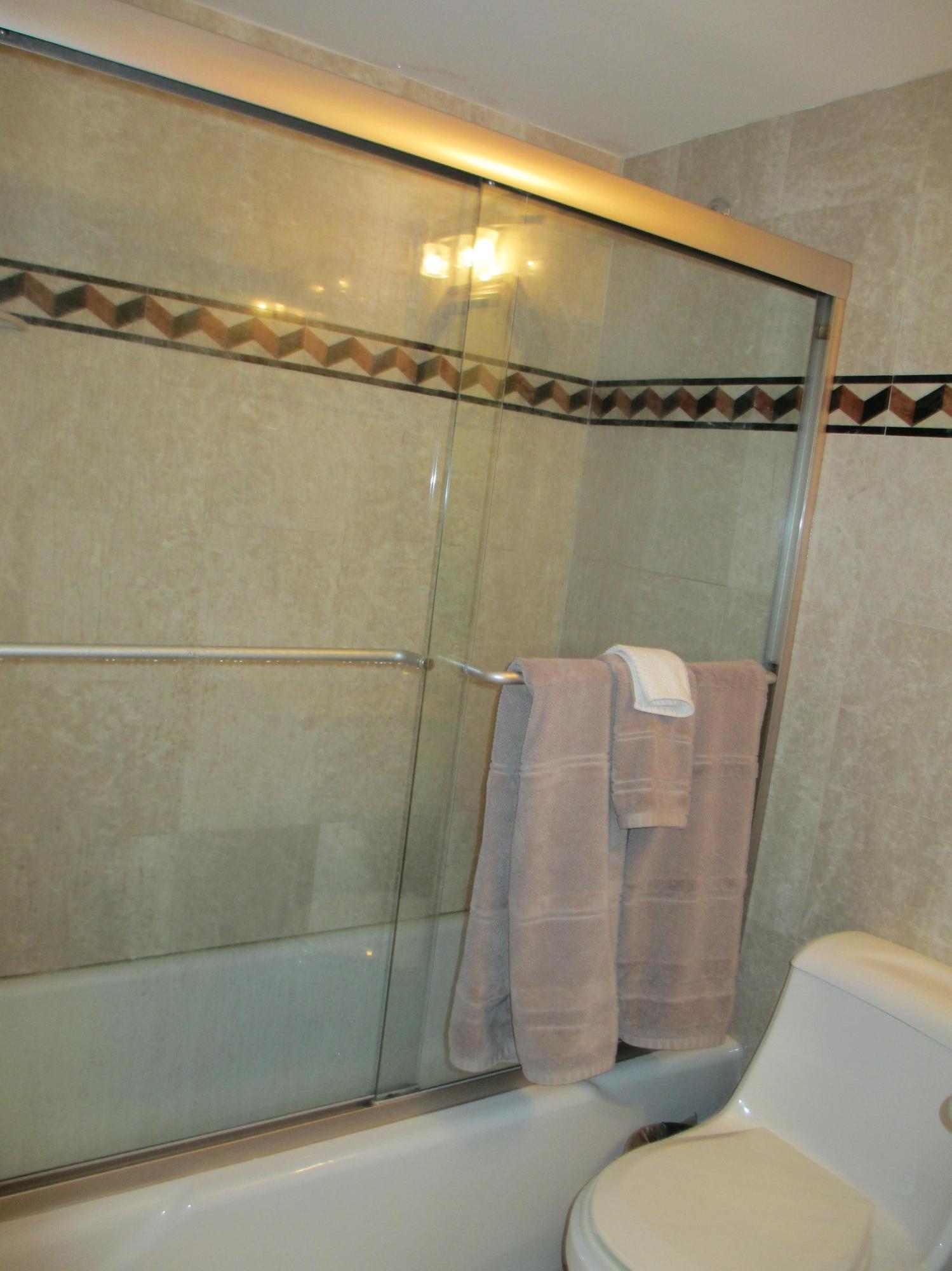 1405 Bridgewood Drive, Unit 1405 Boca Raton, FL 33434 - Photo 31 of 54 a bathroom with a shower and a toilet