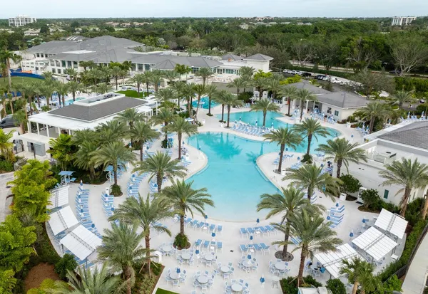 a view of a house with swimming pool and sitting area