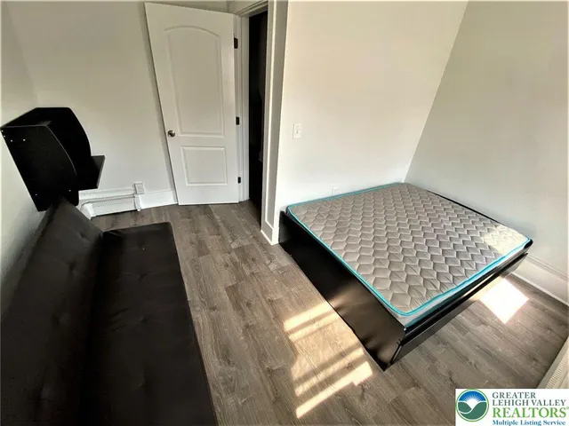 wooden floor with view of hallway