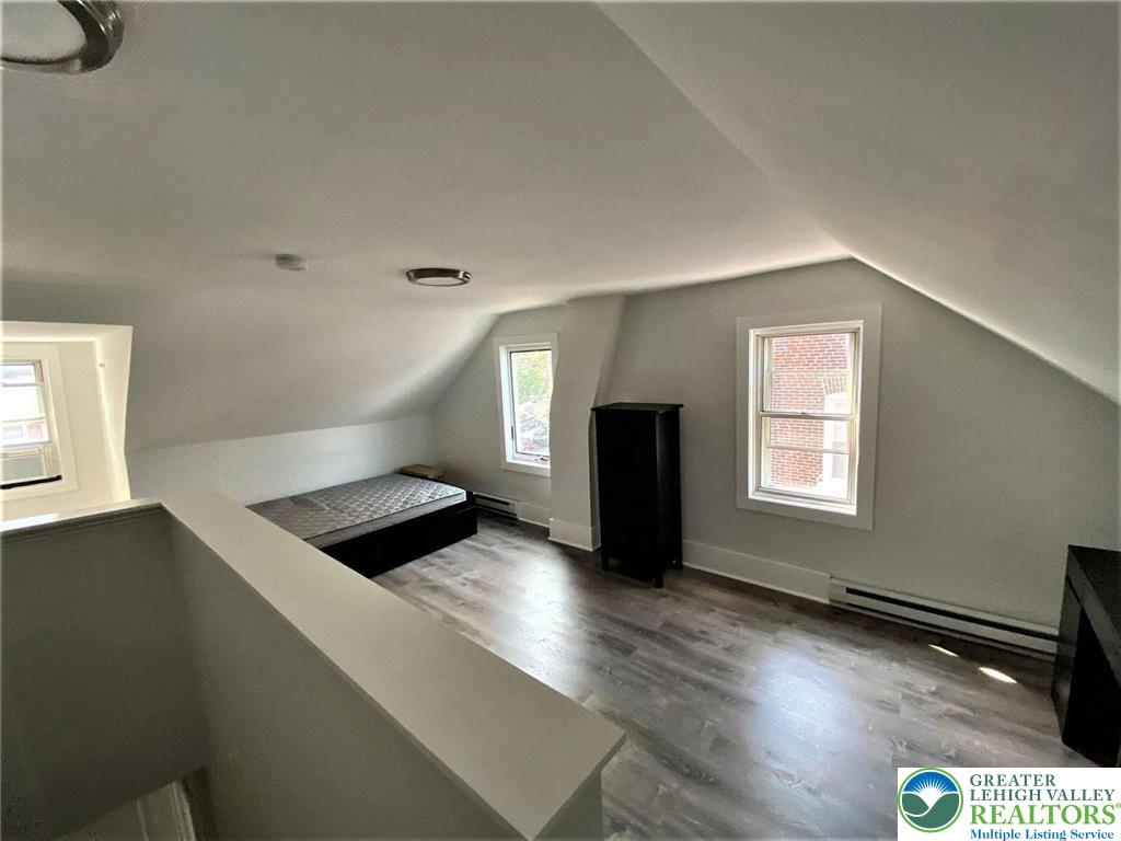 517 Thomas Street Bethlehem, PA 18015 - Photo 26 of 30 a kitchen with granite countertop a stove and a wooden floor