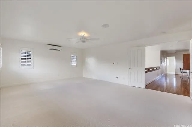 a view of a kitchen and an empty room
