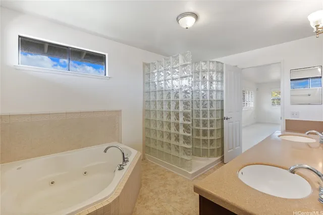 a bathroom with a tub sink and mirror