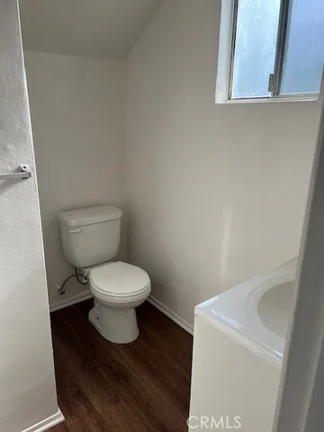 a white toilet sitting next to a white sink