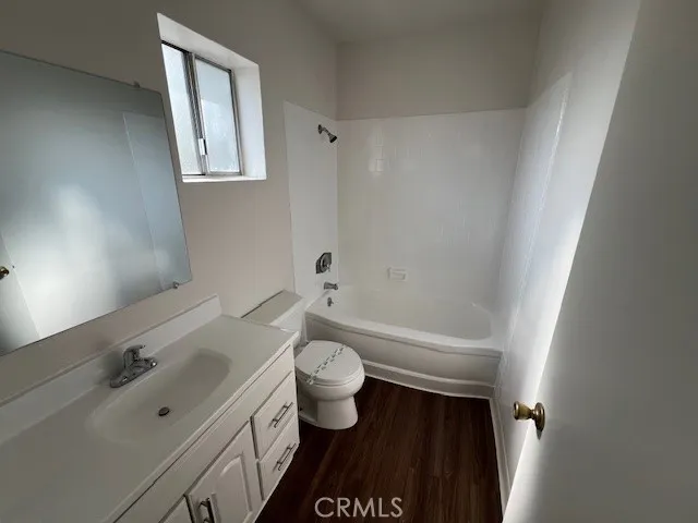 a bathroom with a bathtub sink mirror and toilet