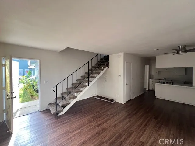 a view of entryway and hall with wooden floor