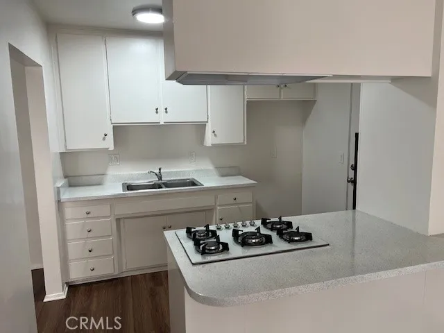 a kitchen with sink a stove and cabinets