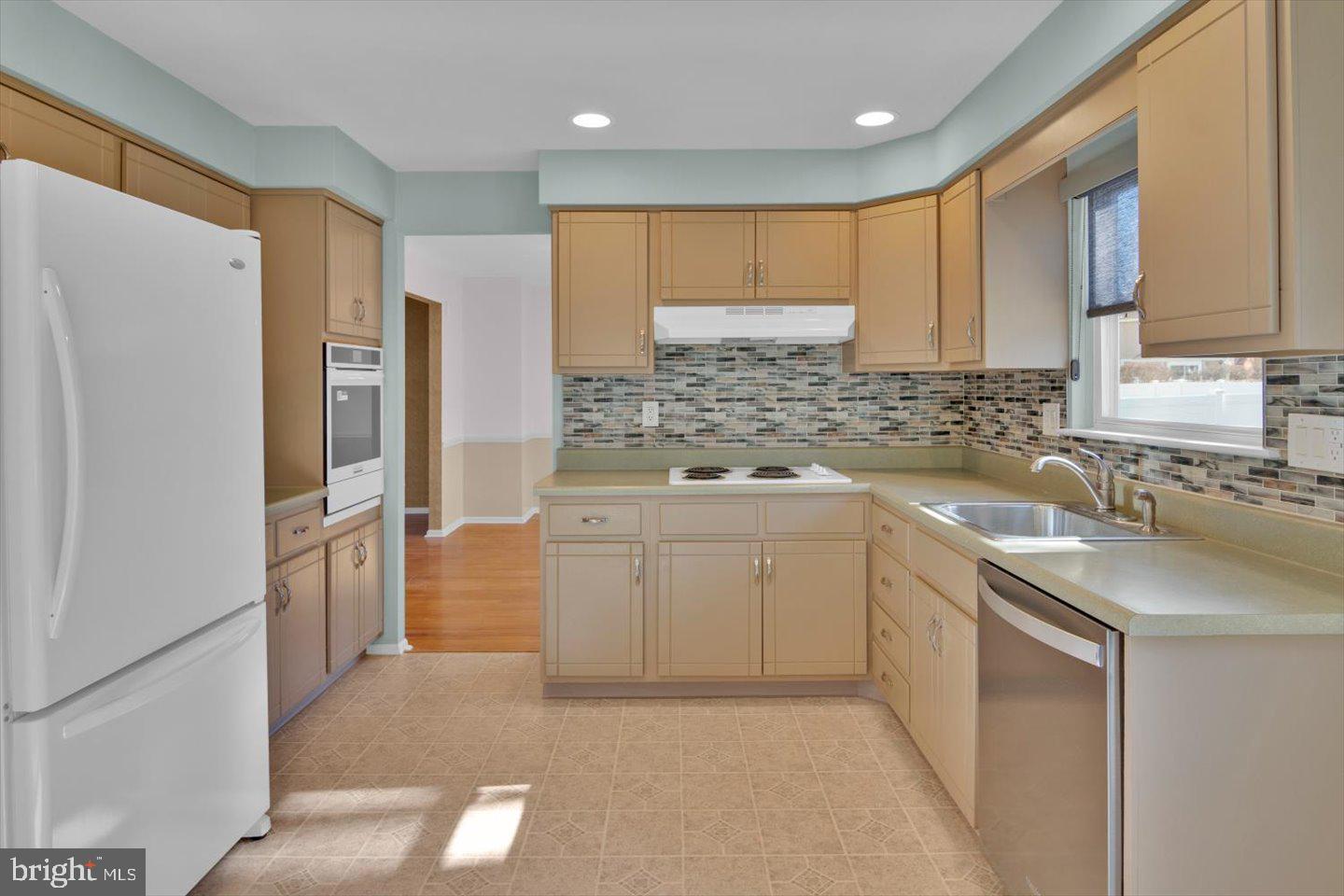 104 Lamp Post Lane Cherry Hill, NJ 08003 - Photo 16 of 44 a kitchen with a refrigerator sink and cabinets