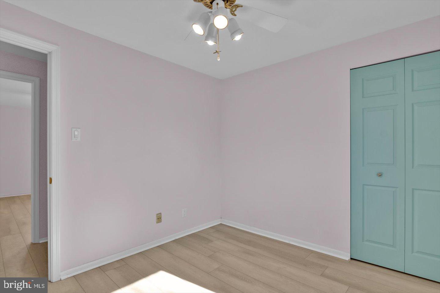 104 Lamp Post Lane Cherry Hill, NJ 08003 - Photo 32 of 44 an empty room with wooden floor and chandelier fan