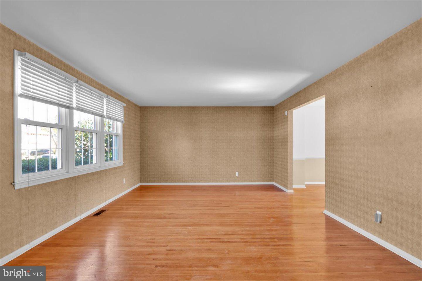 104 Lamp Post Lane Cherry Hill, NJ 08003 - Photo 7 of 44 a view of an empty room with wooden floor and a window