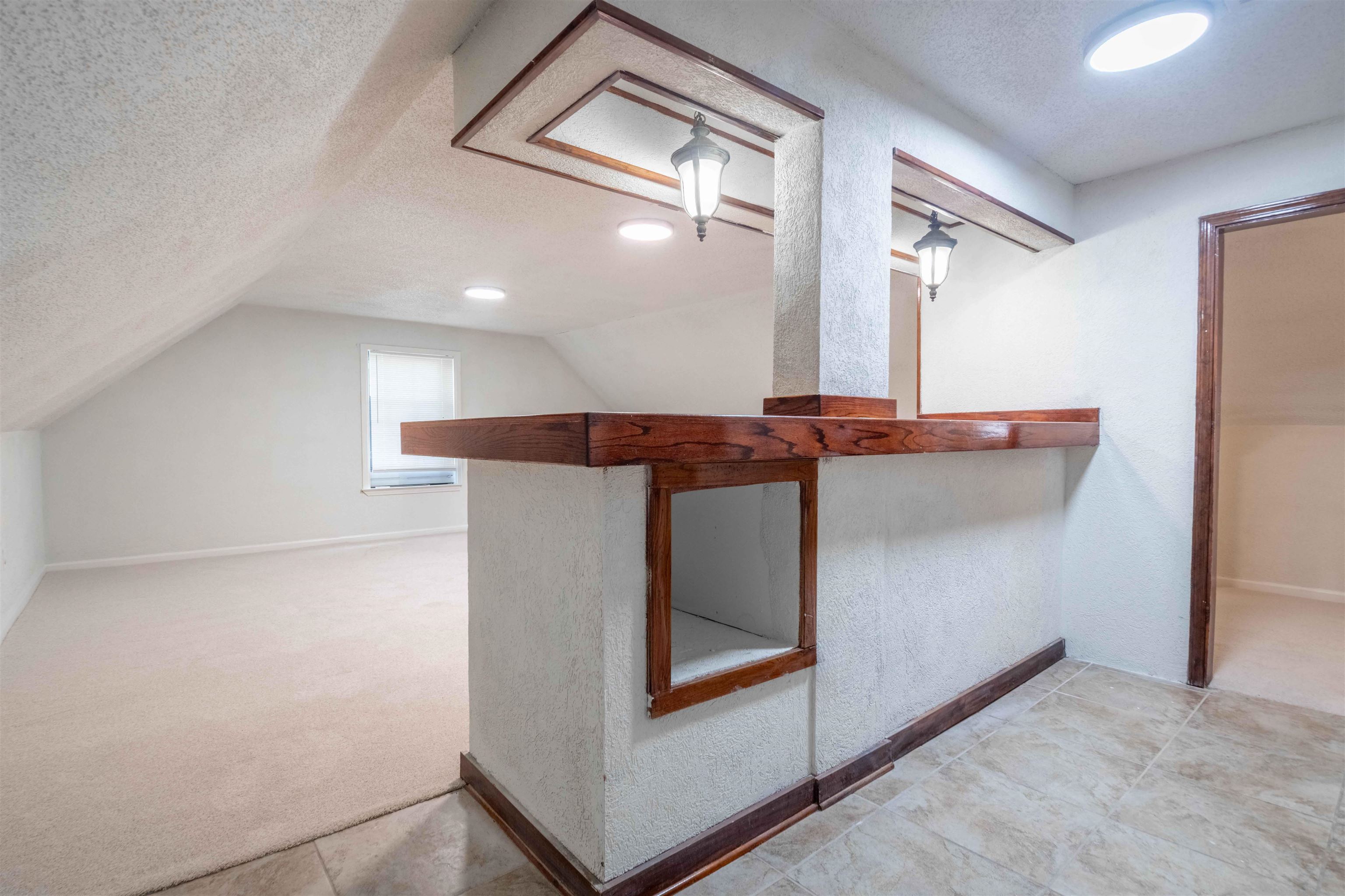 7800 Buck Ridge Cove Memphis, TN 38016 - Photo 34 of 36 Upper-level space featuring a wood-finish bar area with built-in shelving, sconce lighting, and recessed ceiling lights