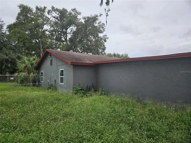 a backyard of a house with lots of green space