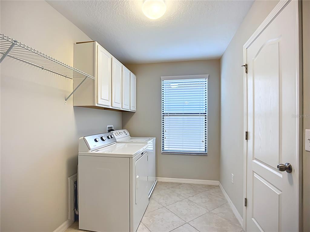 14240 Blue Dasher Drive Riverview, FL 33569 - Photo 19 of 25 a utility room with closet dryer and washer