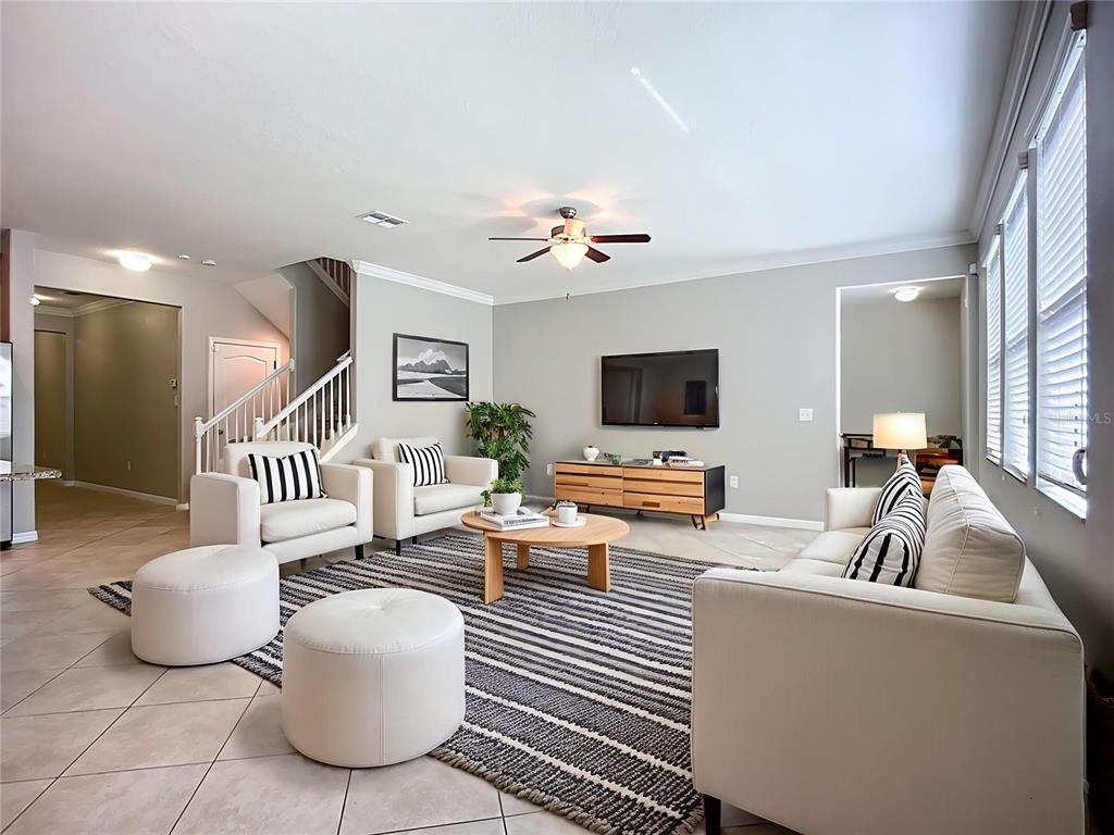 14240 Blue Dasher Drive Riverview, FL 33569 - Photo 2 of 25 a living room with furniture and a flat screen tv