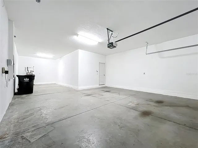 a view of a big room with wooden floor and windows