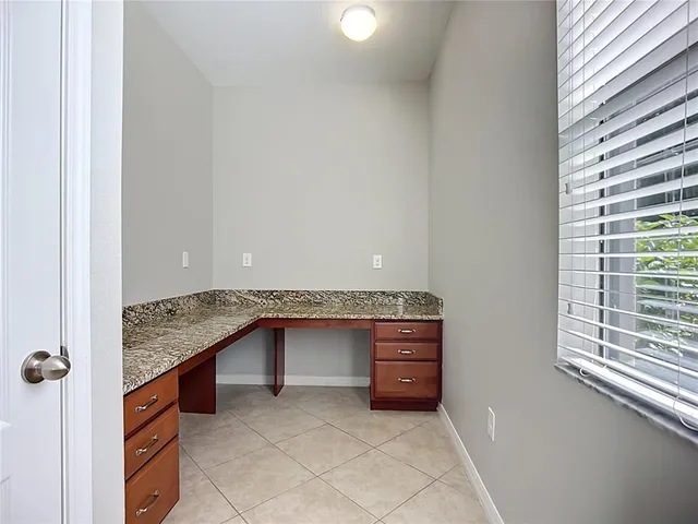 a kitchen with kitchen island a sink and a stove