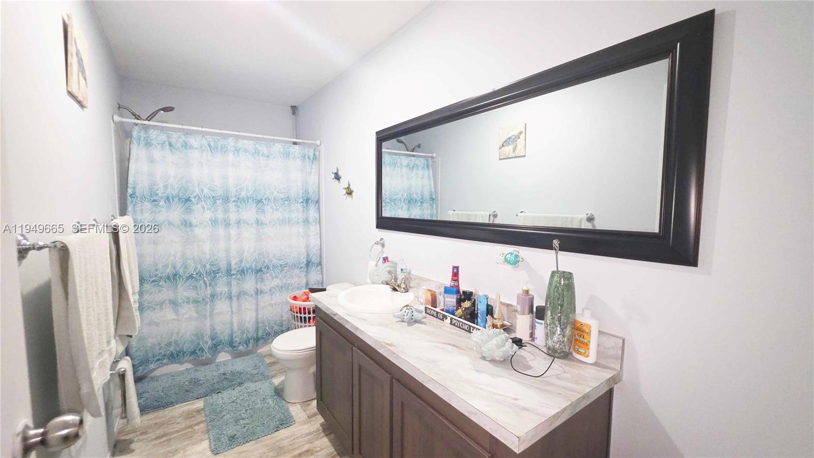 612 Hunting Clb Avenue Clewiston, FL 33440 - Photo 24 of 36 a bathroom with a sink vanity mirror and shower