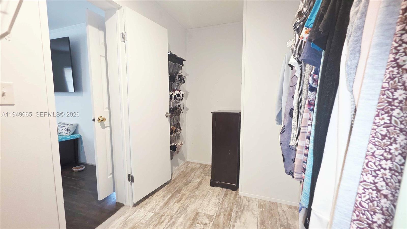 612 Hunting Clb Avenue Clewiston, FL 33440 - Photo 25 of 36 walk in closet with wooden floor washer and dryer