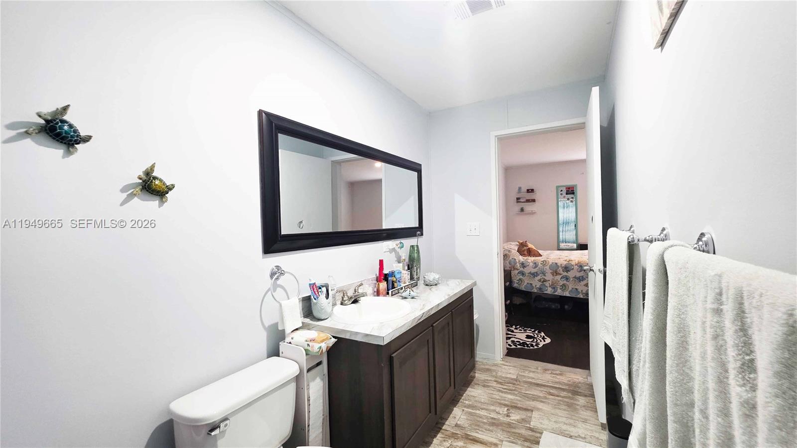 612 Hunting Clb Avenue Clewiston, FL 33440 - Photo 27 of 36 a bathroom with a sink and a mirror