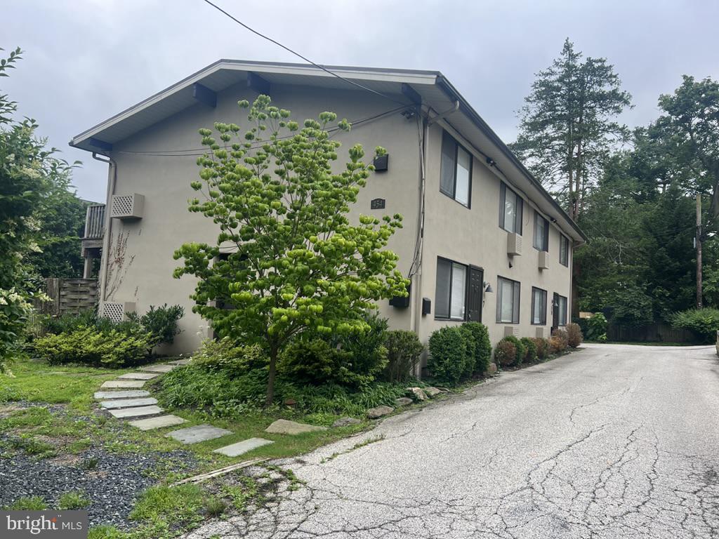 454 Old Lancaster Road, Unit 2 Haverford, PA 19041 - Photo 1 of 15 a front view of a house with garden