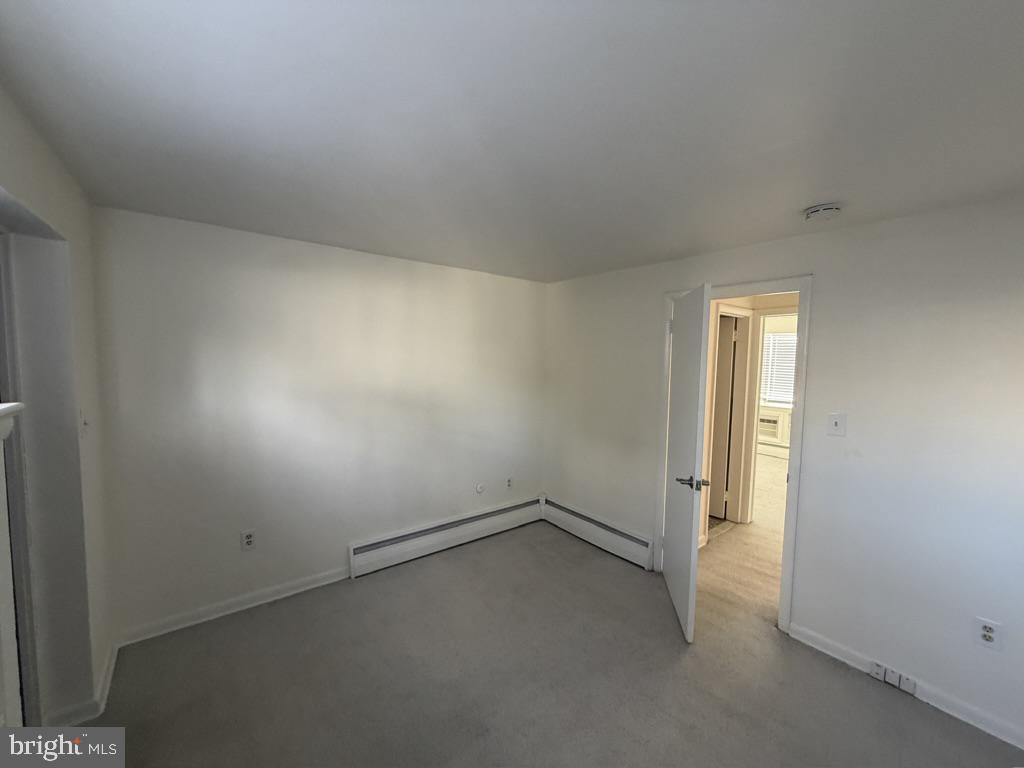 454 Old Lancaster Road, Unit 2 Haverford, PA 19041 - Photo 12 of 15 an empty room with a empty space and windows