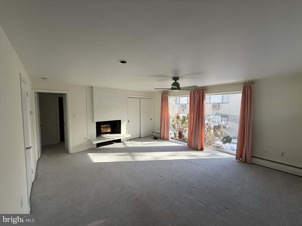 454 Old Lancaster Road, Unit 2 Haverford, PA 19041 - Photo 3 of 15 a view of a livingroom with an empty space and a fireplace