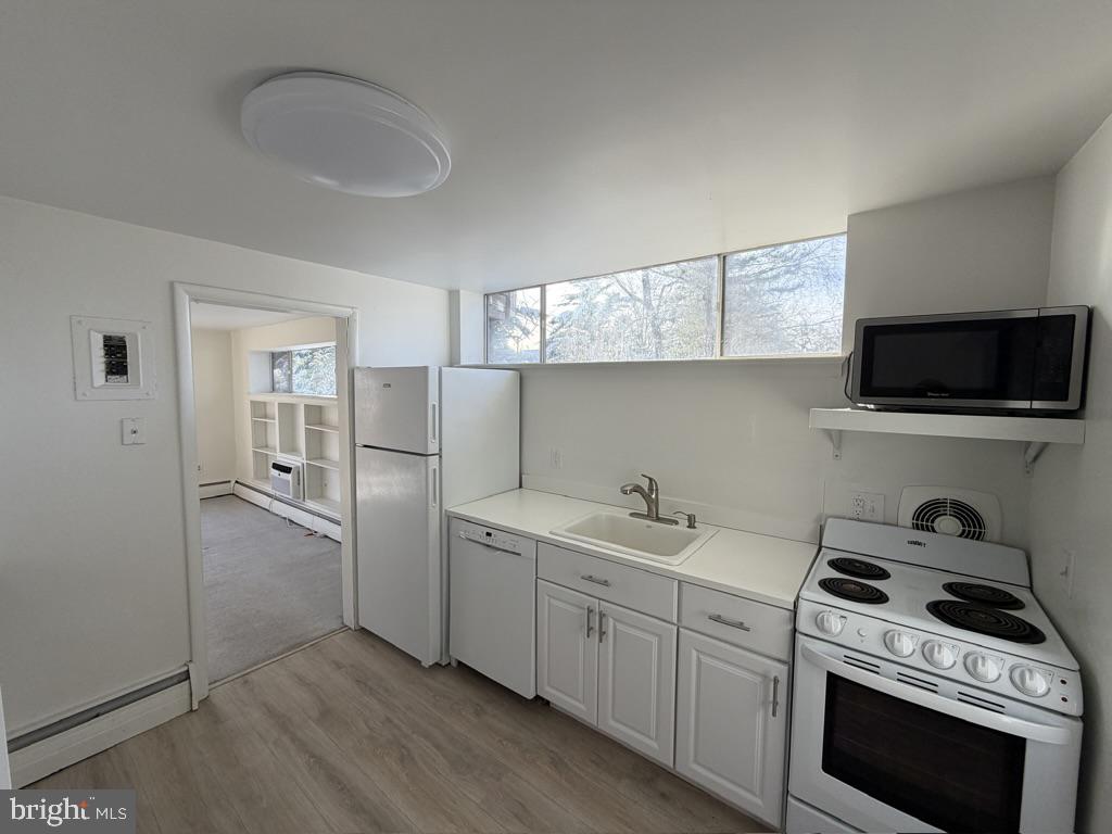 454 Old Lancaster Road, Unit 2 Haverford, PA 19041 - Photo 5 of 15 a kitchen with stainless steel appliances granite countertop a sink stove and refrigerator