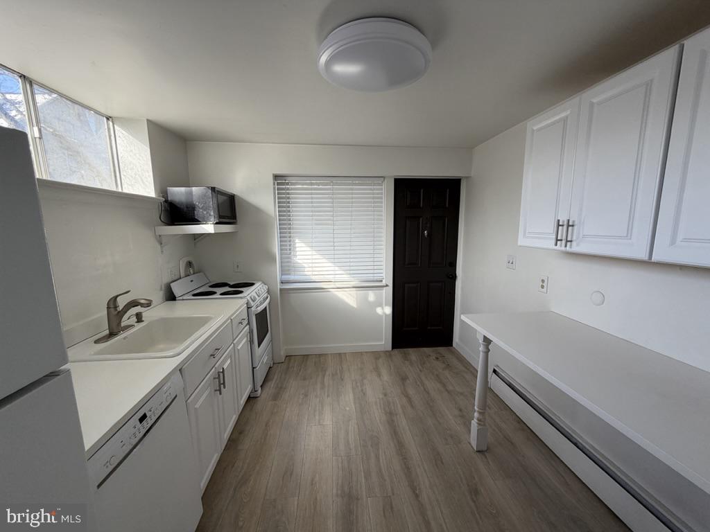 454 Old Lancaster Road, Unit 2 Haverford, PA 19041 - Photo 6 of 15 a kitchen with sink cabinets and stainless steel appliances