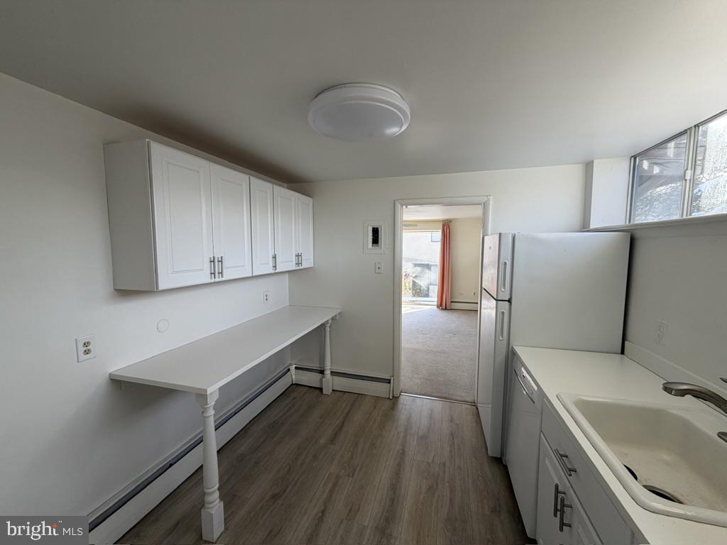 454 Old Lancaster Road, Unit 2 Haverford, PA 19041 - Photo 7 of 15 a kitchen with a refrigerator and sink