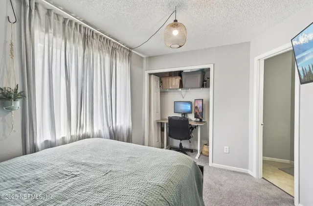 a bedroom with a bed and a chair