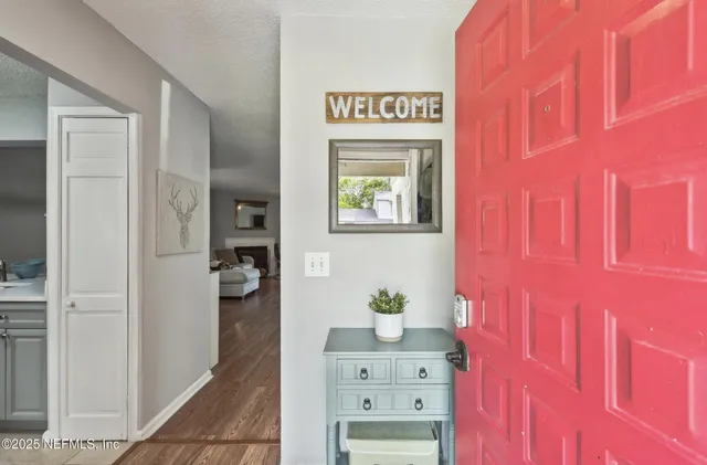 a view of an entryway with wooden floor