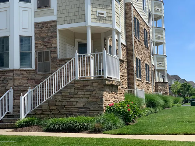 a view of a brick building next to a yard