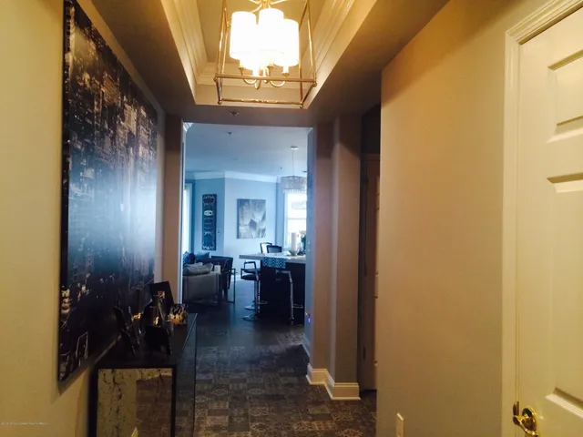 a view of a porch with chairs and potted plants