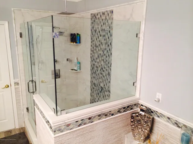 a bathroom with a shower and a sink