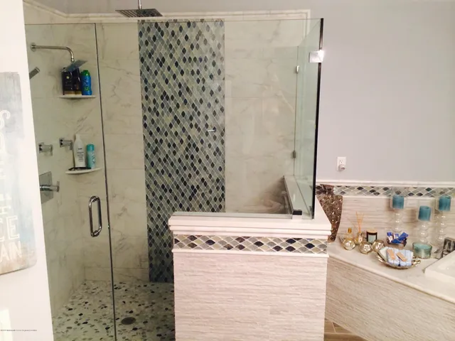 a bathroom with a granite countertop shower and a sink