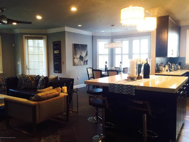 a living room with couch and large windows