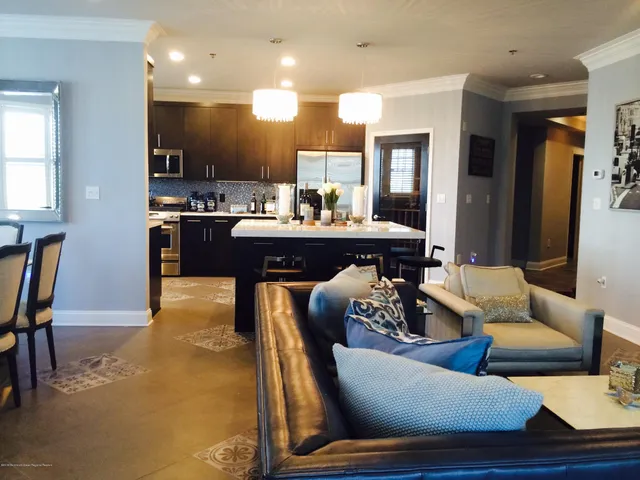 a living room with furniture and kitchen view