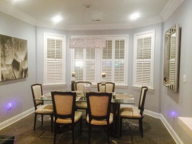 a view of a dining room with furniture and windows