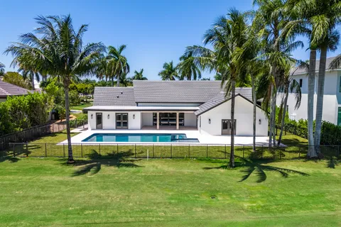 a aerial view of a house with swimming pool and a yard