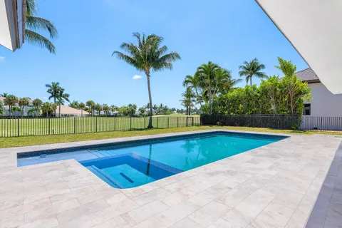 a aerial view of a house with a yard patio and swimming pool